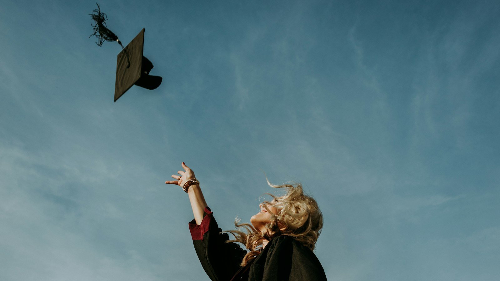 Graduate tossing a cap into the sky
