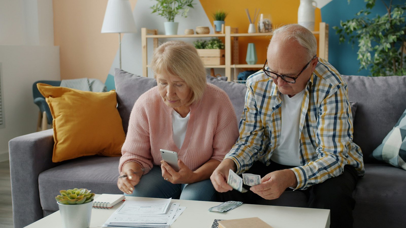 Older couple reviewing bills and household finances at home