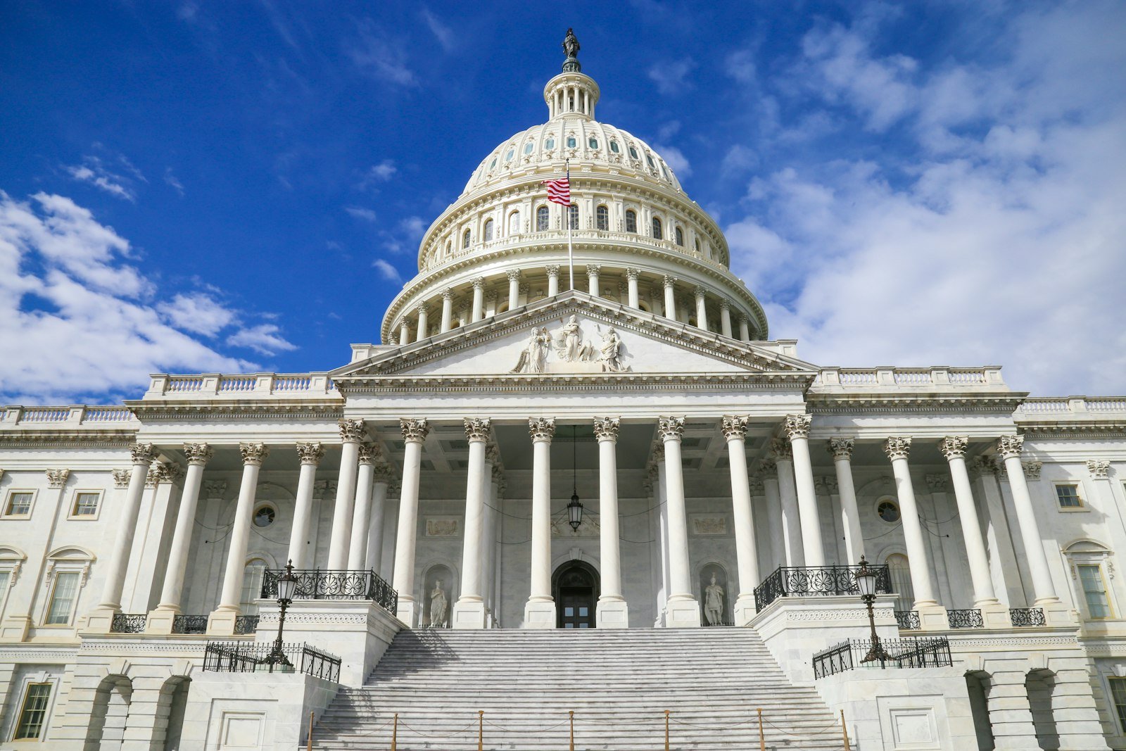 The United States Capitol building with its white dome against a blue sky